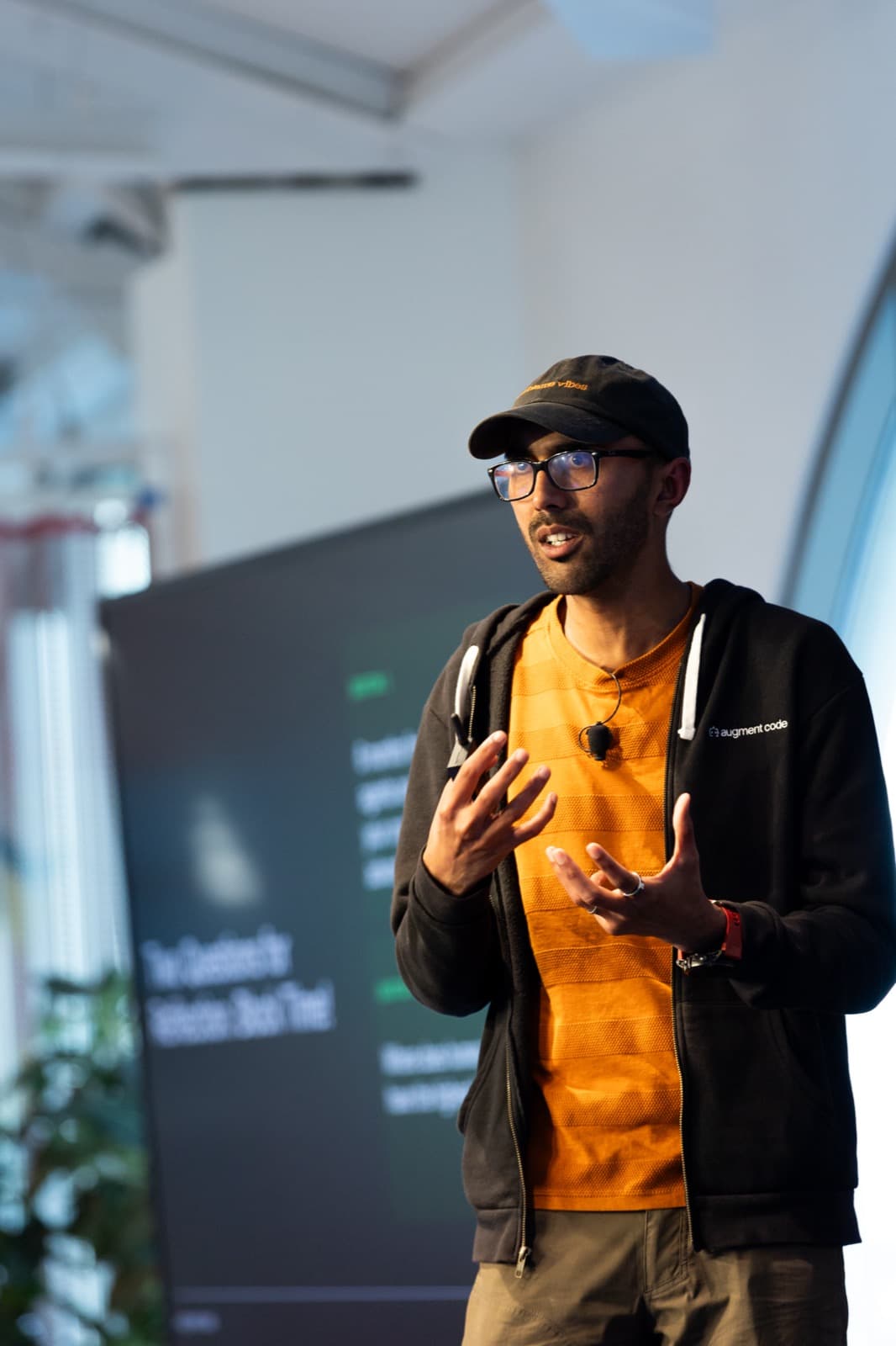 Vinay Perneti, VP of Engineering at Augment Code, speaking on stage